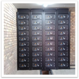 Indoor battery storage system installed against a brick wall